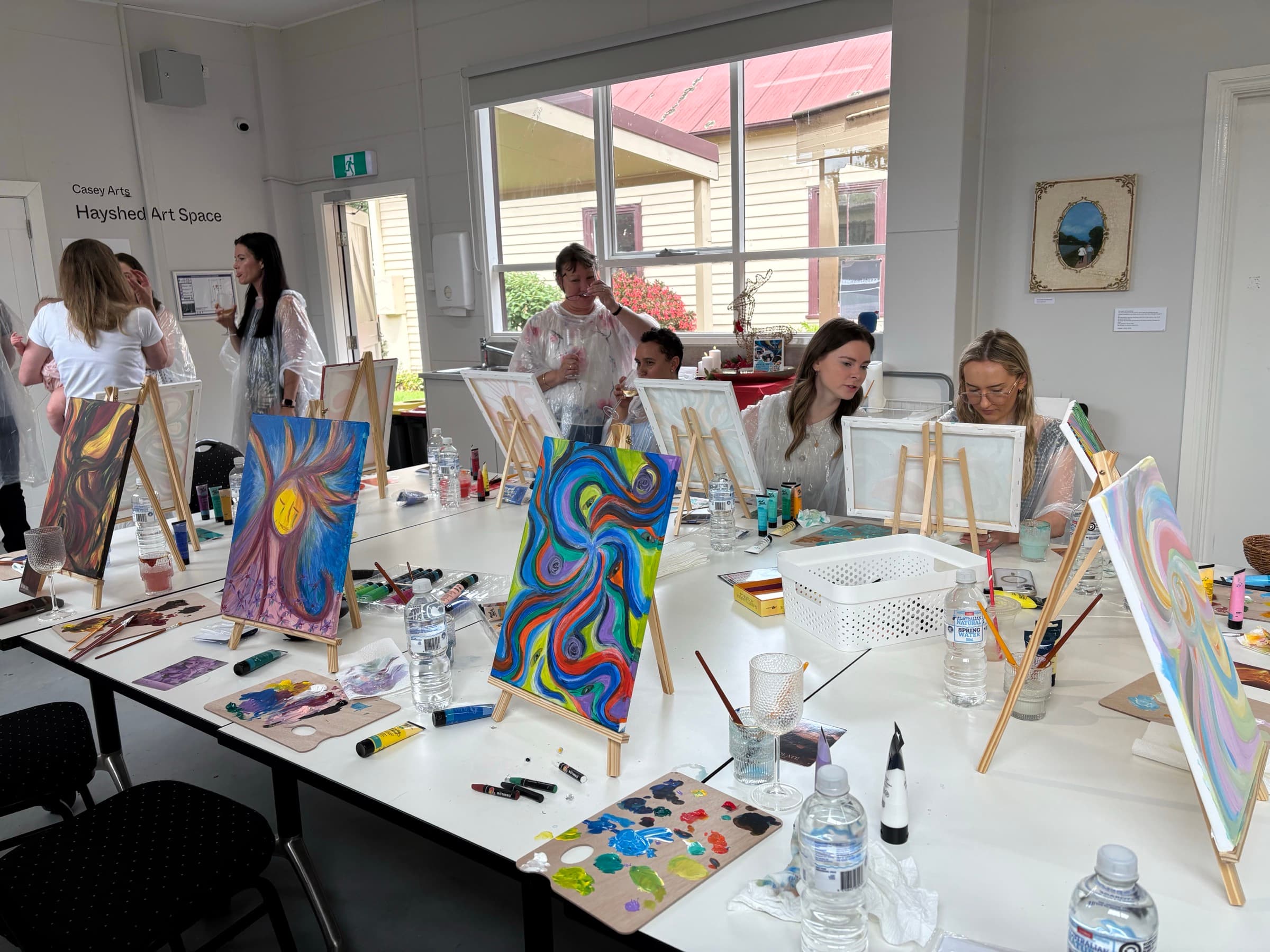 Workshop setup with easels, paints, and brushes