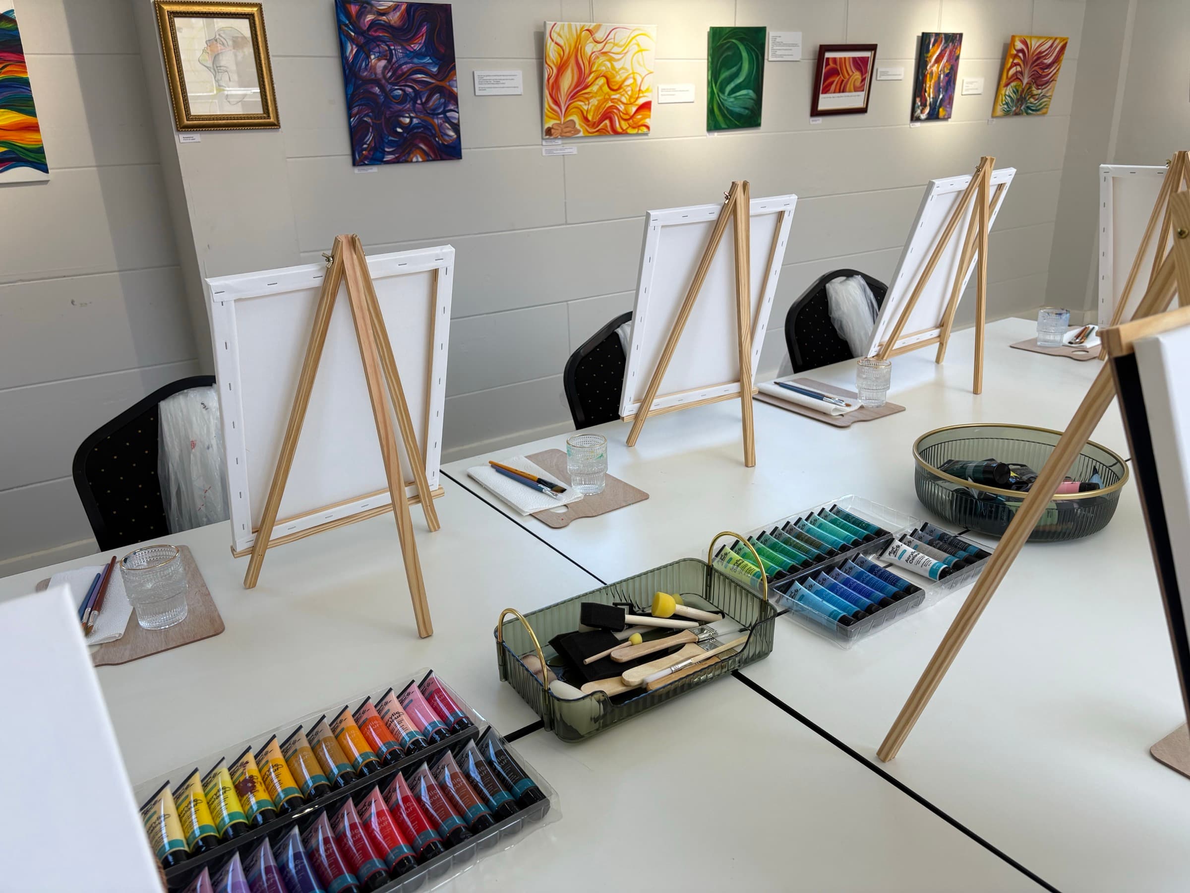 Vibrant paintings on easels during a group session